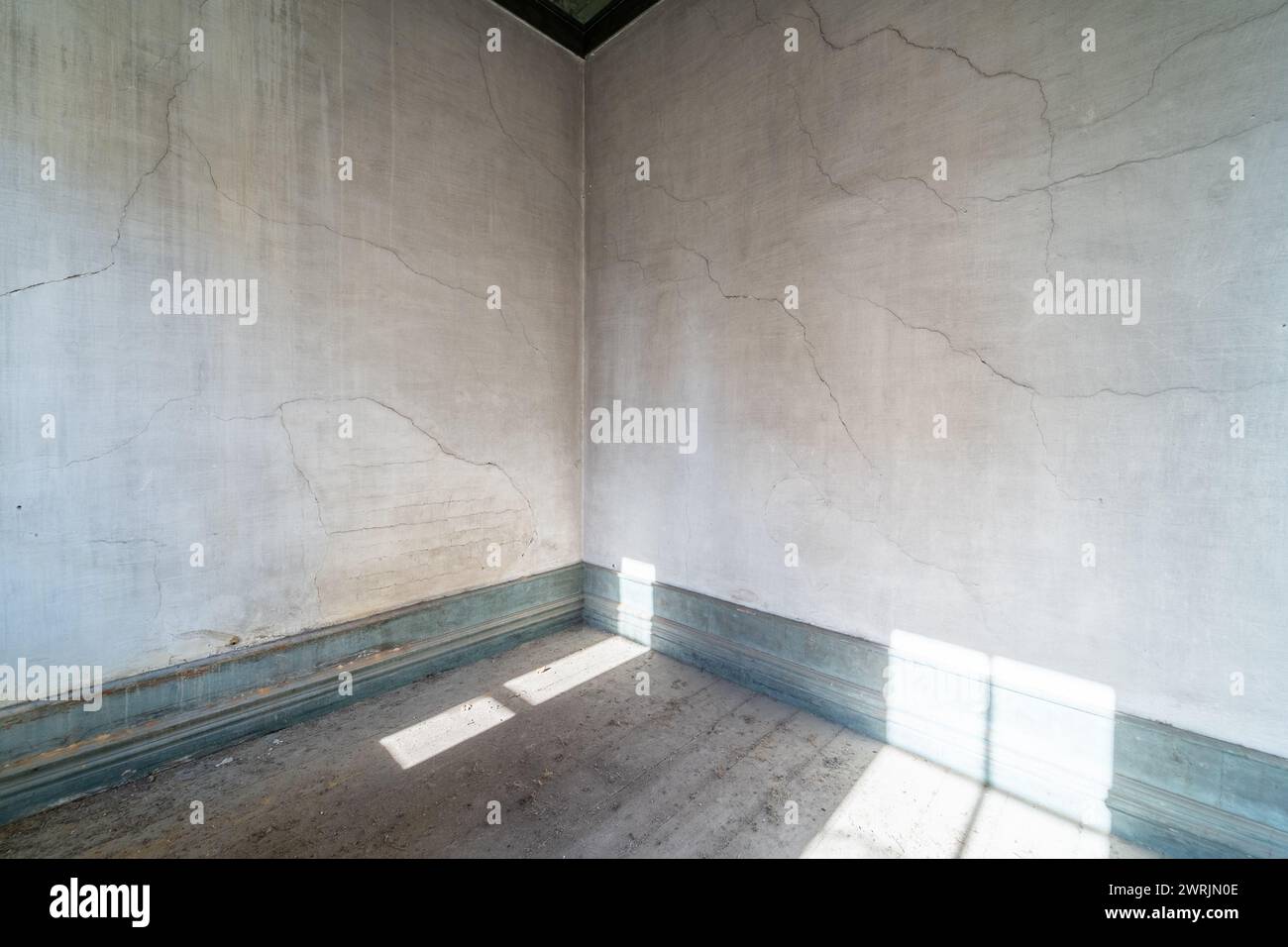 Empty room from old, grunge abandoned house with light from the windows Stock Photo