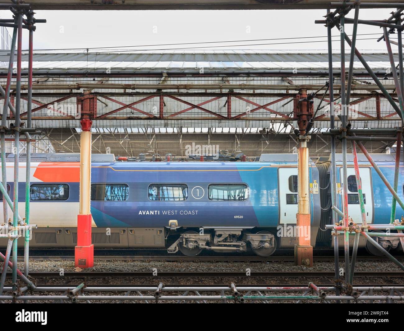 Train stationary by a platform at the railway station in Crewe, England. Stock Photo