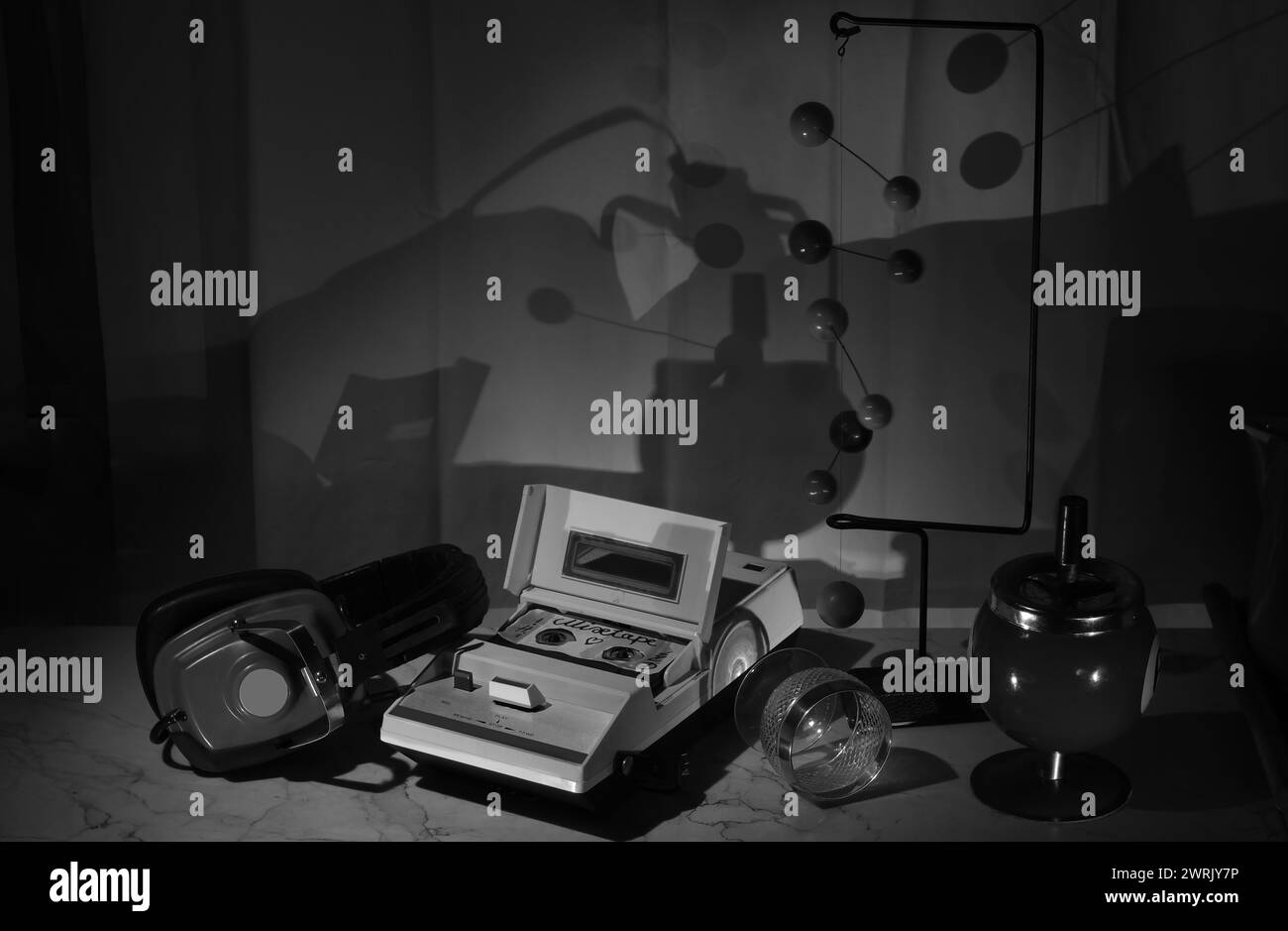 vintage cassette tape recorder and old headphone in a seventies objects arrangement.Black and white image. Stock Photo