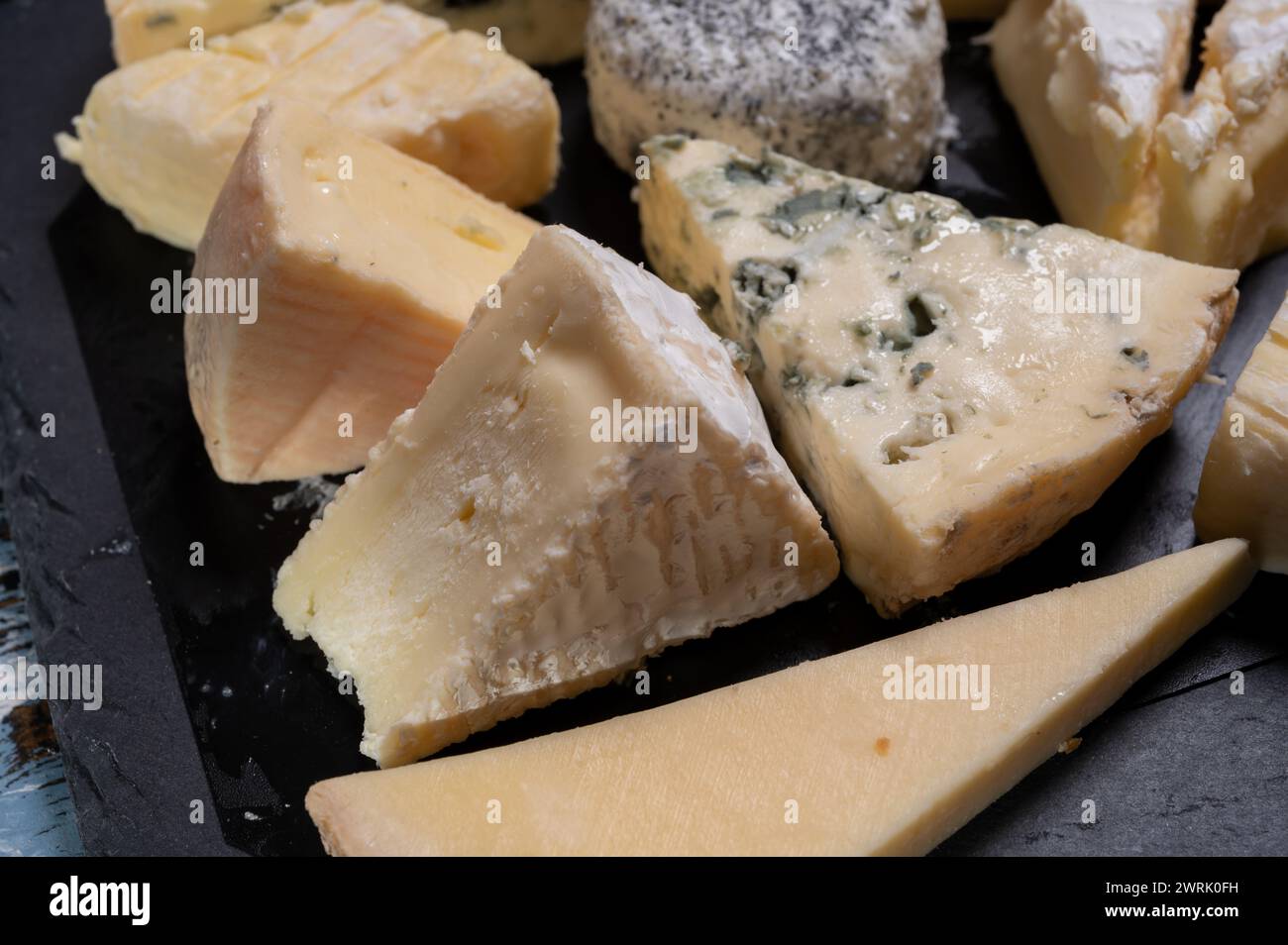 Tasting plate with many small pieces of different French cheeses, variety of cheeses Stock Photo