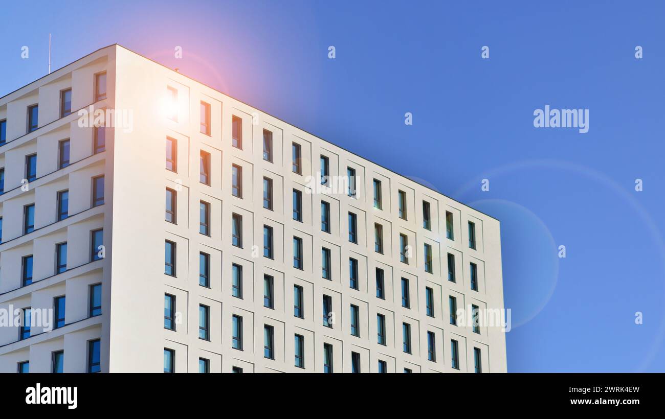 View of a white modern apartment building. Perfect symmetry with blue ...