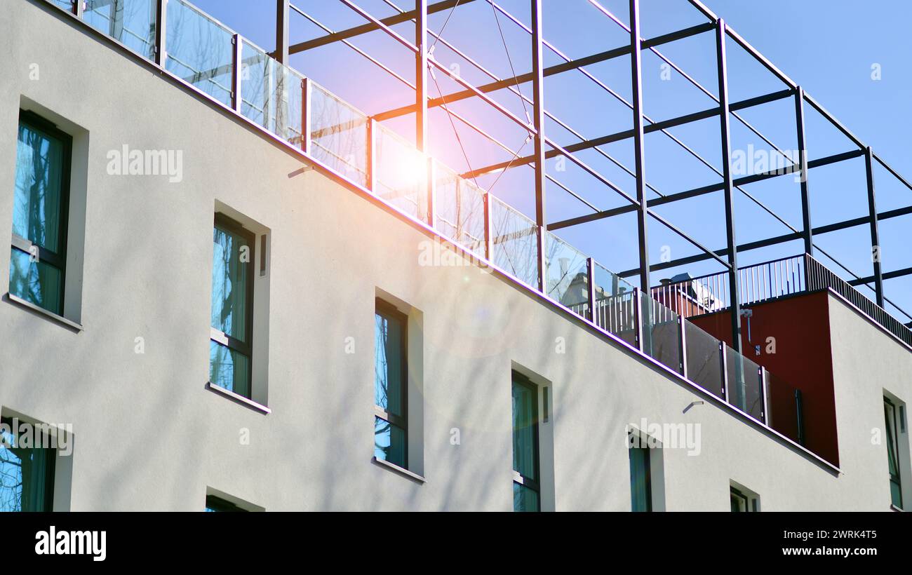 Picture of View of a white modern apartment building. Perfect symmetry with blue ...