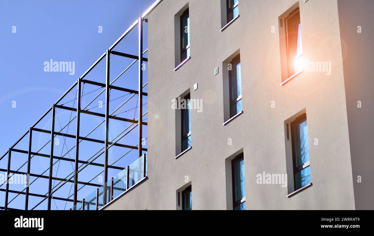 Picture of View of a white modern apartment building. Perfect symmetry with blue ...