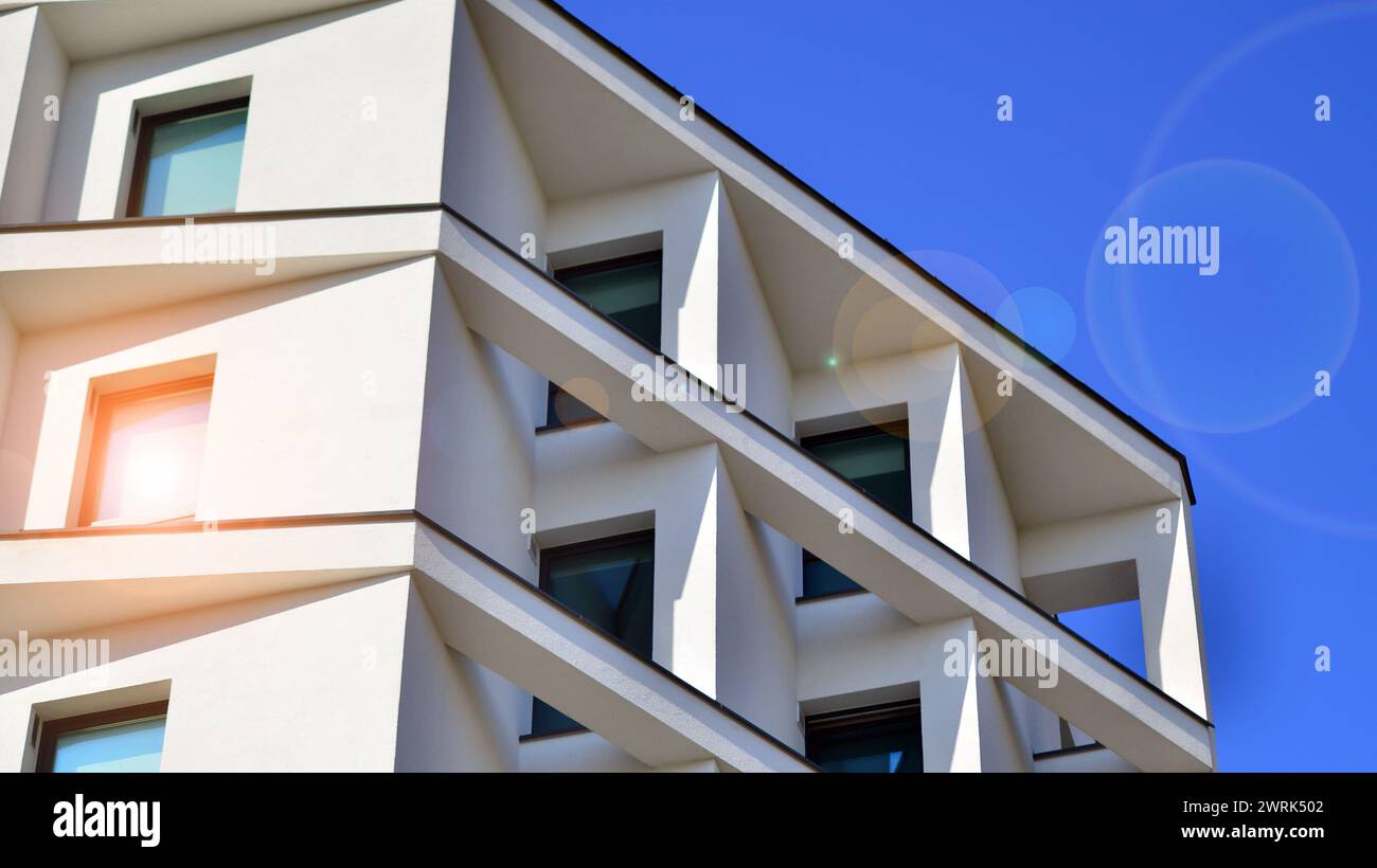 View of View of a white modern apartment building. Perfect symmetry with blue ...