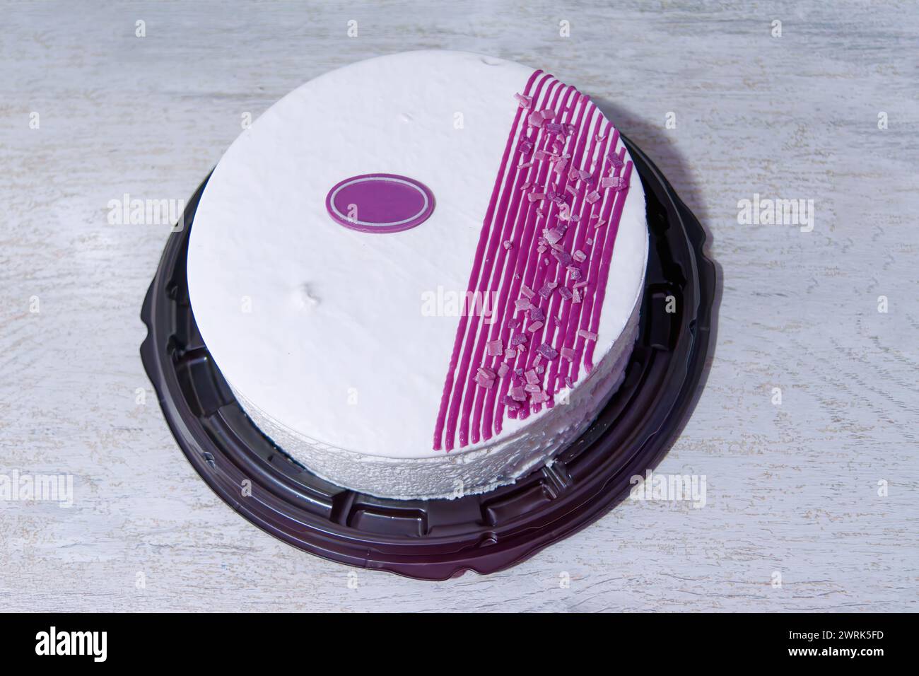 Festive sponge fruit cake with lilac and white cream. View from above. Stock Photo