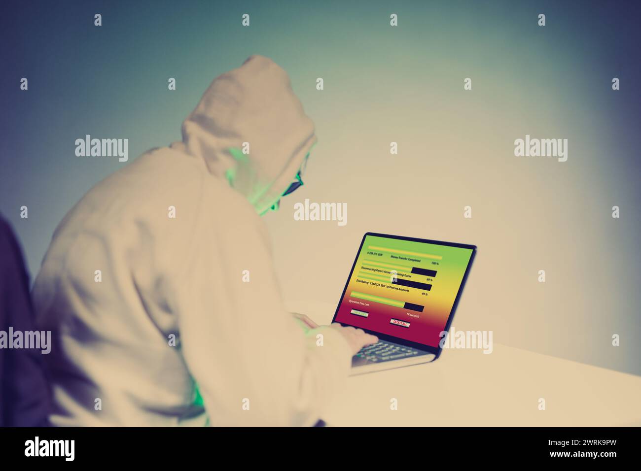 Older criminal man using computer for remote money robbery Stock Photo