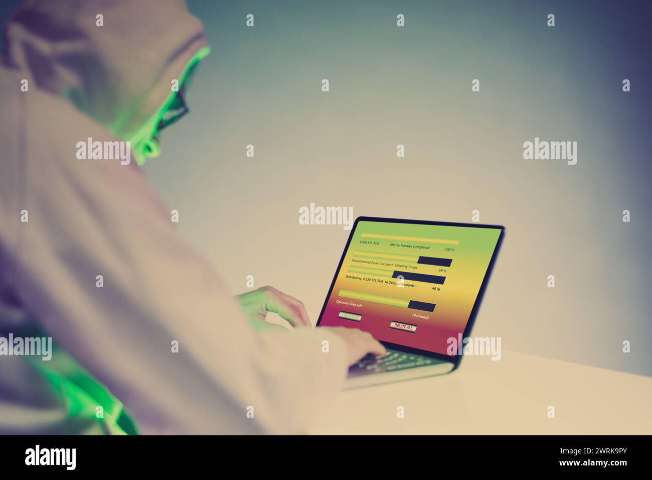 Older criminal man using computer for remote money robbery Stock Photo