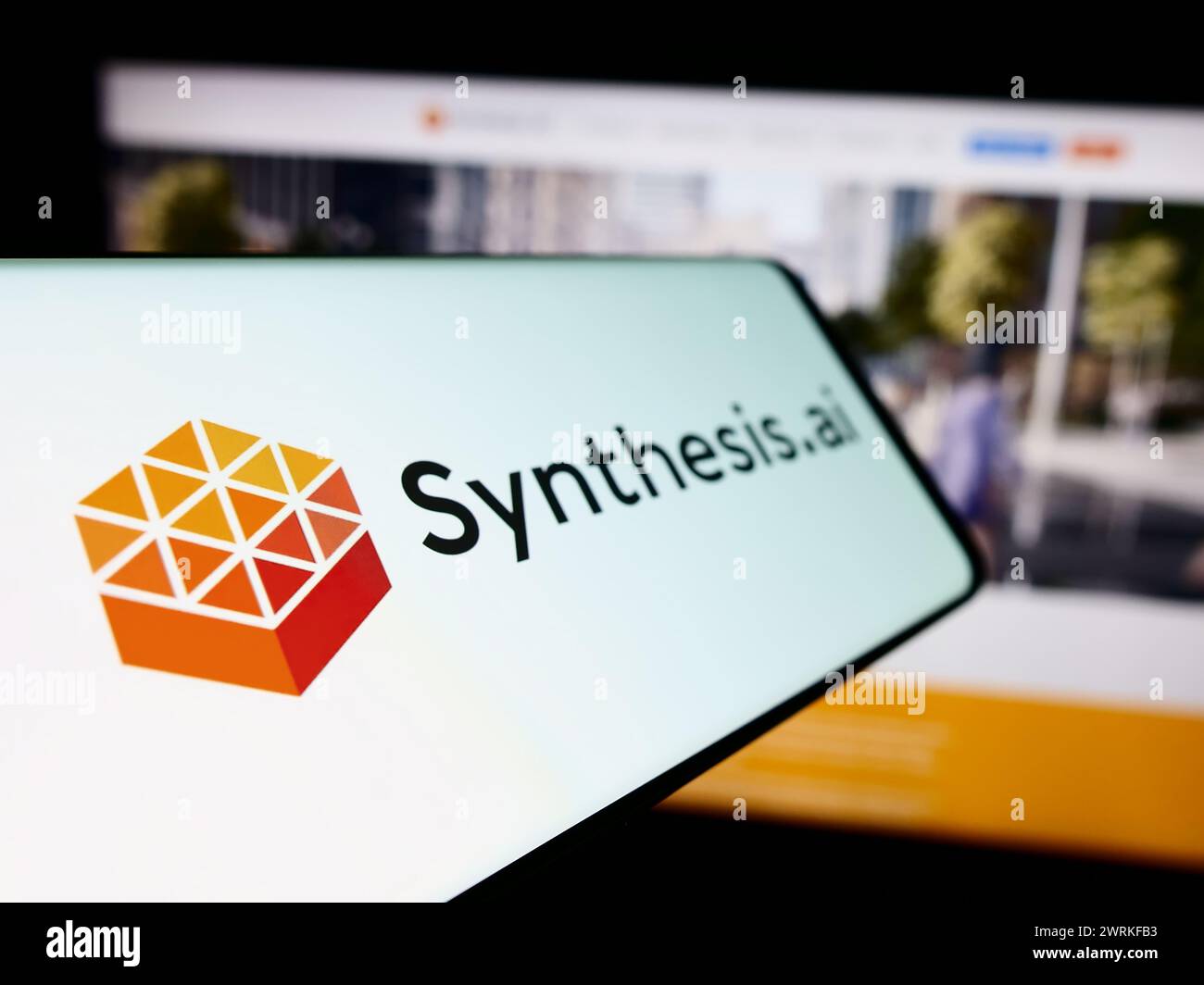 Cellphone with logo of American artificial intelligence company Synthesis AI Inc. in front of business website. Focus on left of phone display. Stock Photo