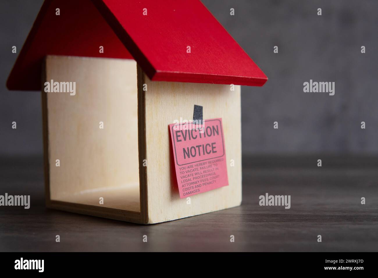 Closeup image of toy house and eviction notice Stock Photo - Alamy