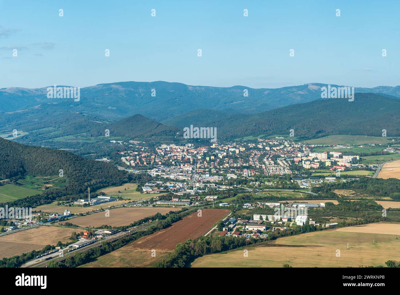 Roznava city with hills of Slovenske rudohorie above from Brzotinska skala viewpoint in Slovakia during autumn afternoon Stock Photo