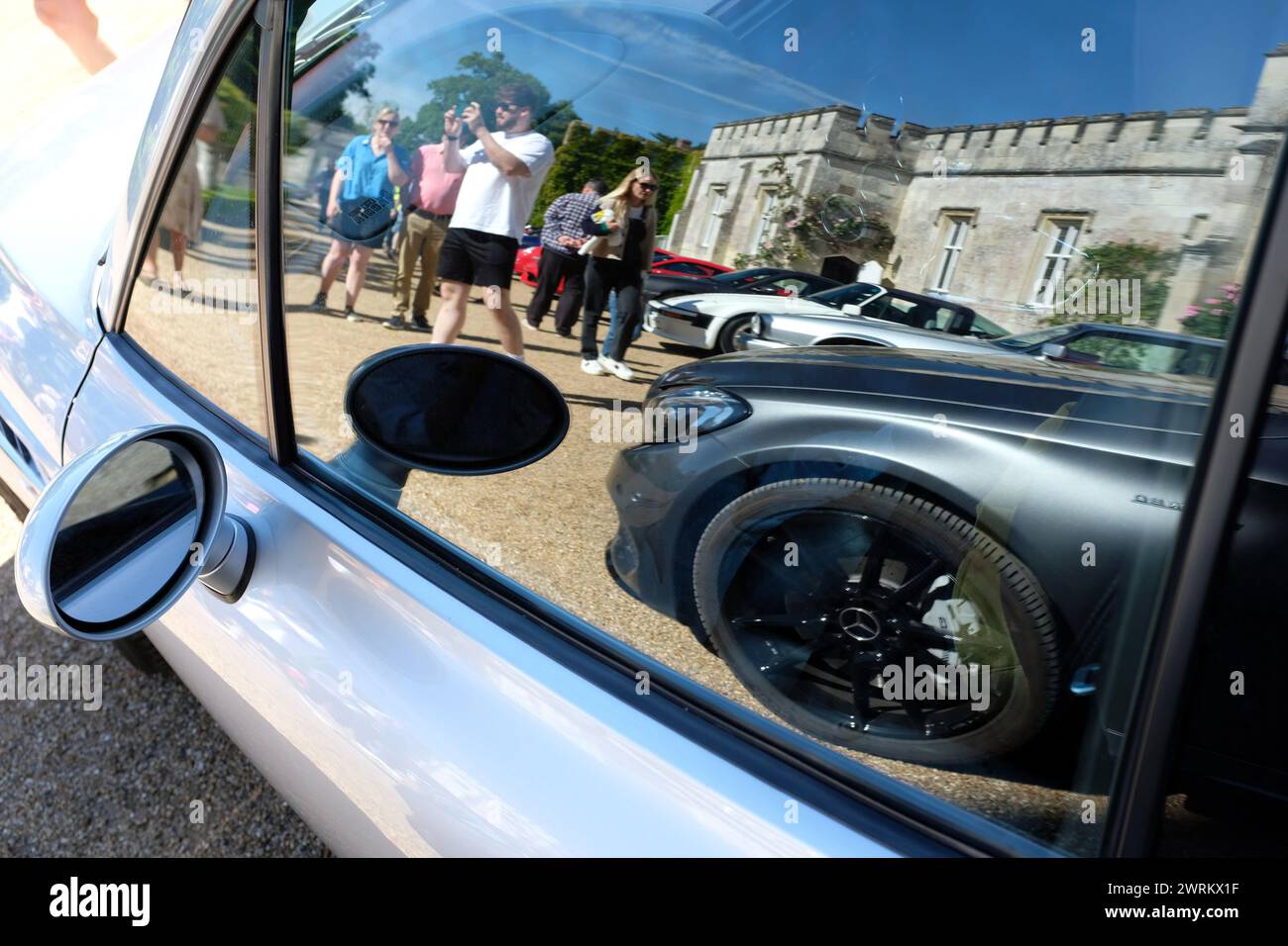 A reflection of a car show in the passenger window glass. Wiltshire UK 2023. Stock Photo