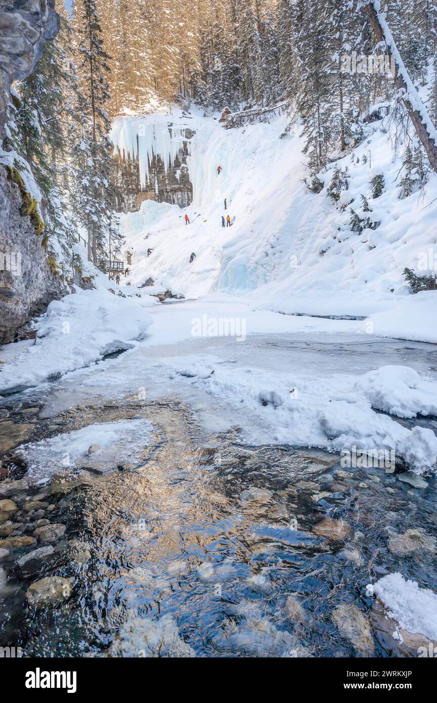 Distant unrecognizable ice climbers on the frozen Upper Falls at Johnston Canyon in Banff National Park, Alberta, Canada Stock Photo