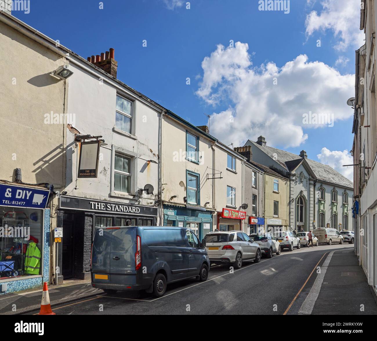 Shops at Fore Street, Torpoint in south east Cornwall. Offering a local range of retail and services on the Rame Peninsula. Towards the end is the Gra Stock Photo