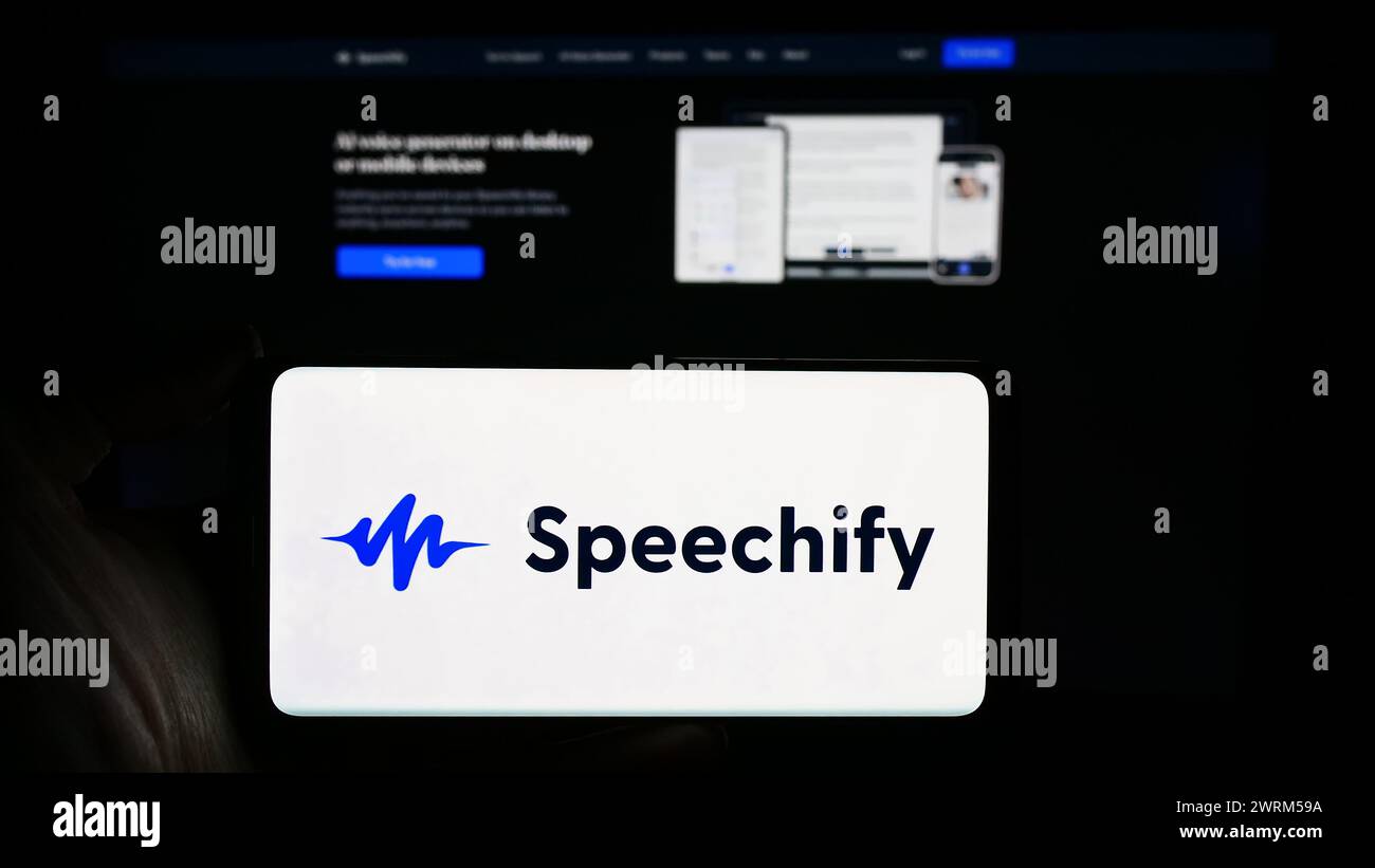 Person holding cellphone with logo of text-to-speech app company Speechify Inc. in front of business webpage. Focus on phone display. Stock Photo