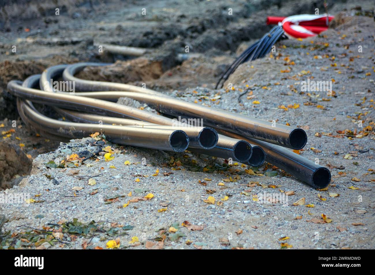 Laying of plastic communication pipes at the construction site of road ...