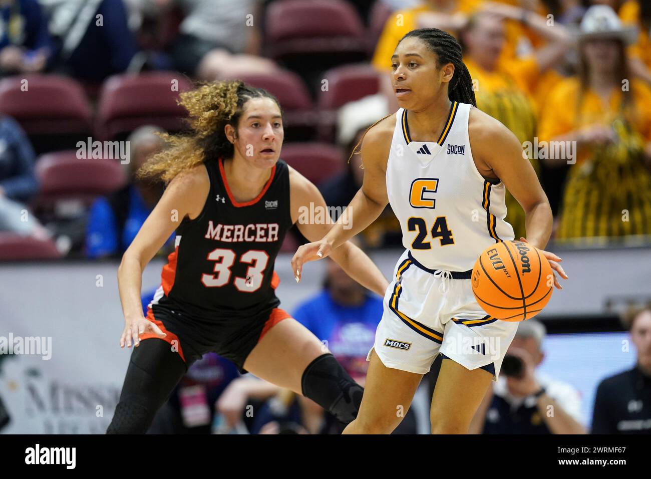 Chattanooga guard Jada Guinn (24) controls the ball against Mercer forward Summah Evans (33