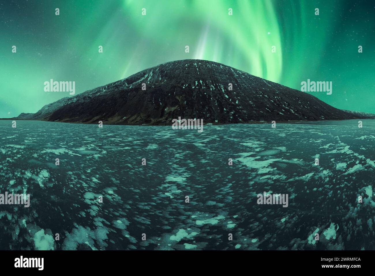 A spectacular display of Aurora Borealis illuminates the sky above a ...