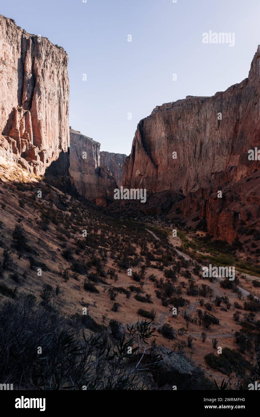 Image showcasing First light of sunrise touches the massive walls of a Patagonian canyon ...