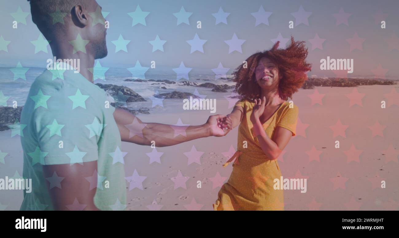 Young African American couple holding hands on the beach Stock Photo ...