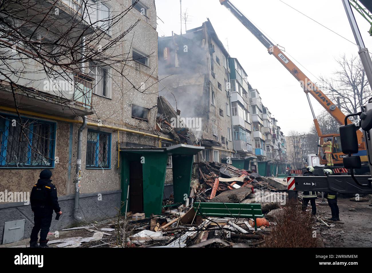 SUMY, UKRAINE - MARCH 13, 2023 - Rescuers use high-altitude equipment and special tools to searching for people under the rubble of a five-story residential building destroyed by one of the Shahed drones launched by Russian troops to attack Sumy, north-eastern Ukraine. Stock Photo