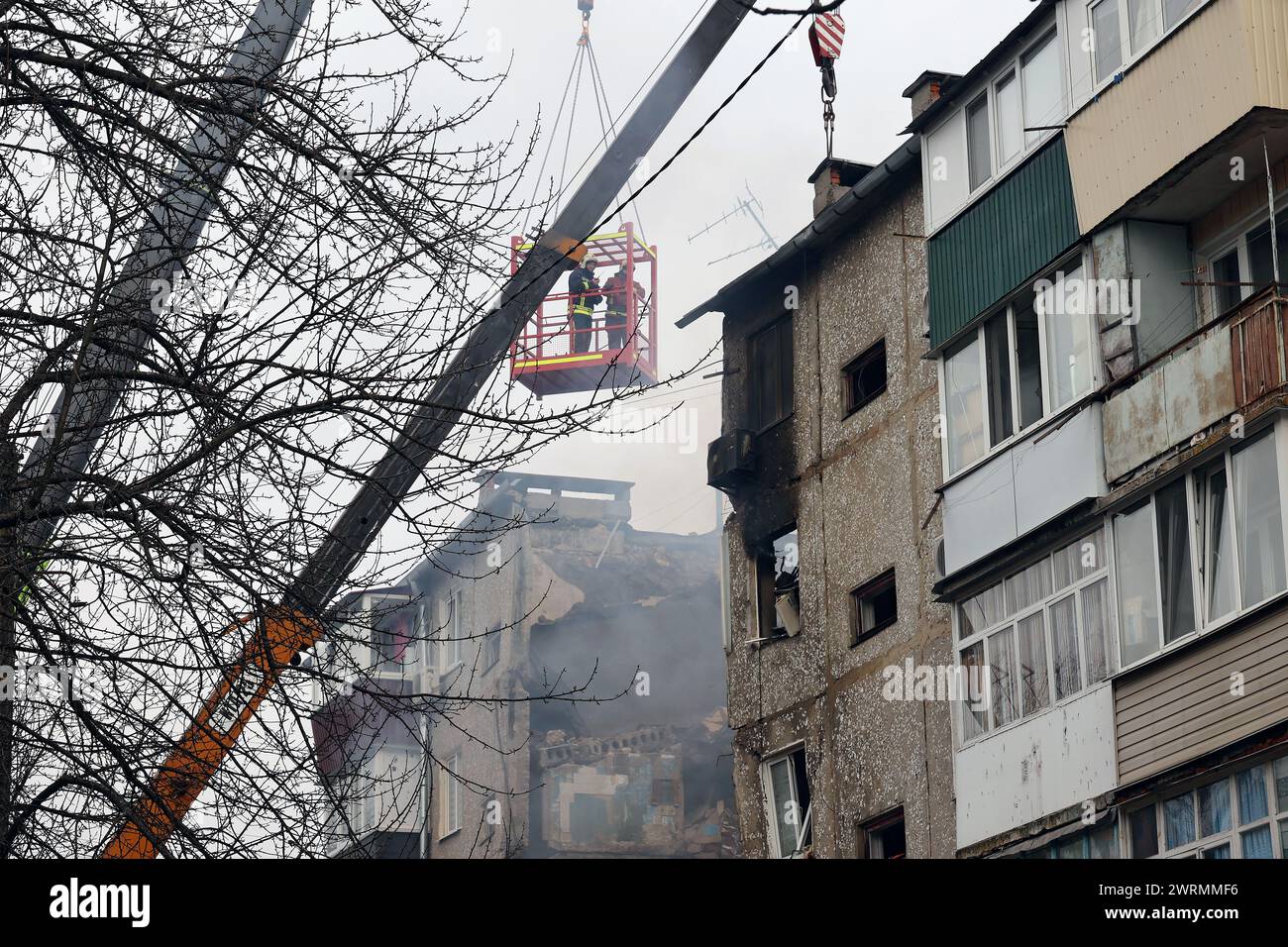 SUMY, UKRAINE - MARCH 13, 2023 - Rescuers use high-altitude equipment and special tools to searching for people under the rubble of a five-story residential building destroyed by one of the Shahed drones launched by Russian troops to attack Sumy, north-eastern Ukraine. Stock Photo