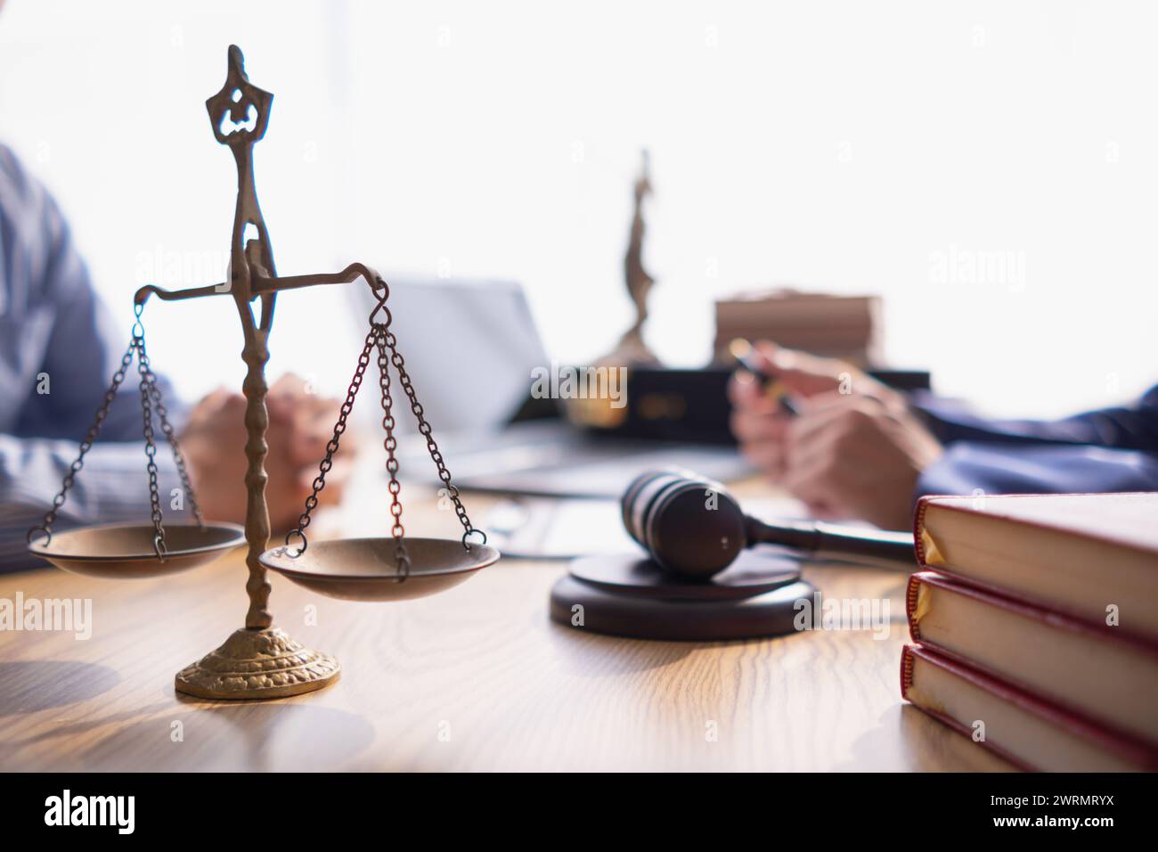 Brass scales are placed on lawyers desks in legal advice offices as a symbol of fairness and integrity in the High Court decision making. Brass scales Stock Photo