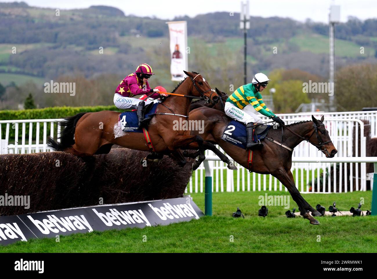 Fact To File ridden by jockey Mark Walsh (right) on their way to winning the Brown Advisory Novices' Chase on day two of the 2024 Cheltenham Festival at Cheltenham Racecourse. Picture date: Wednesday March 13, 2024. Stock Photo