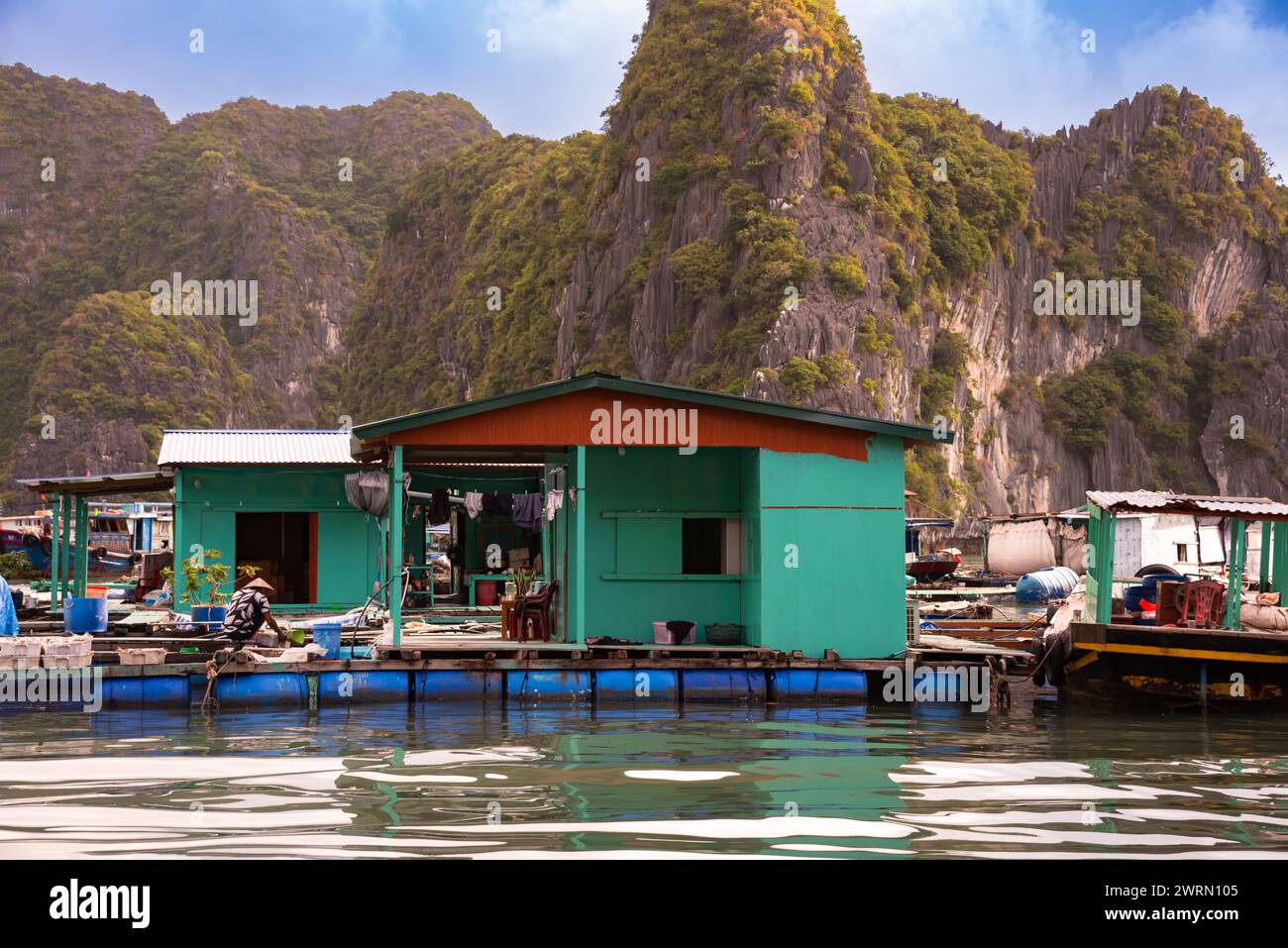 Floating village in sea bay in Vietnam Stock Photo - Alamy
