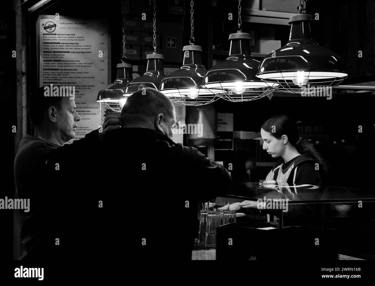 Bartender prepares drinks for customers at Lisbon's Mercado da Ribeira Stock Photo