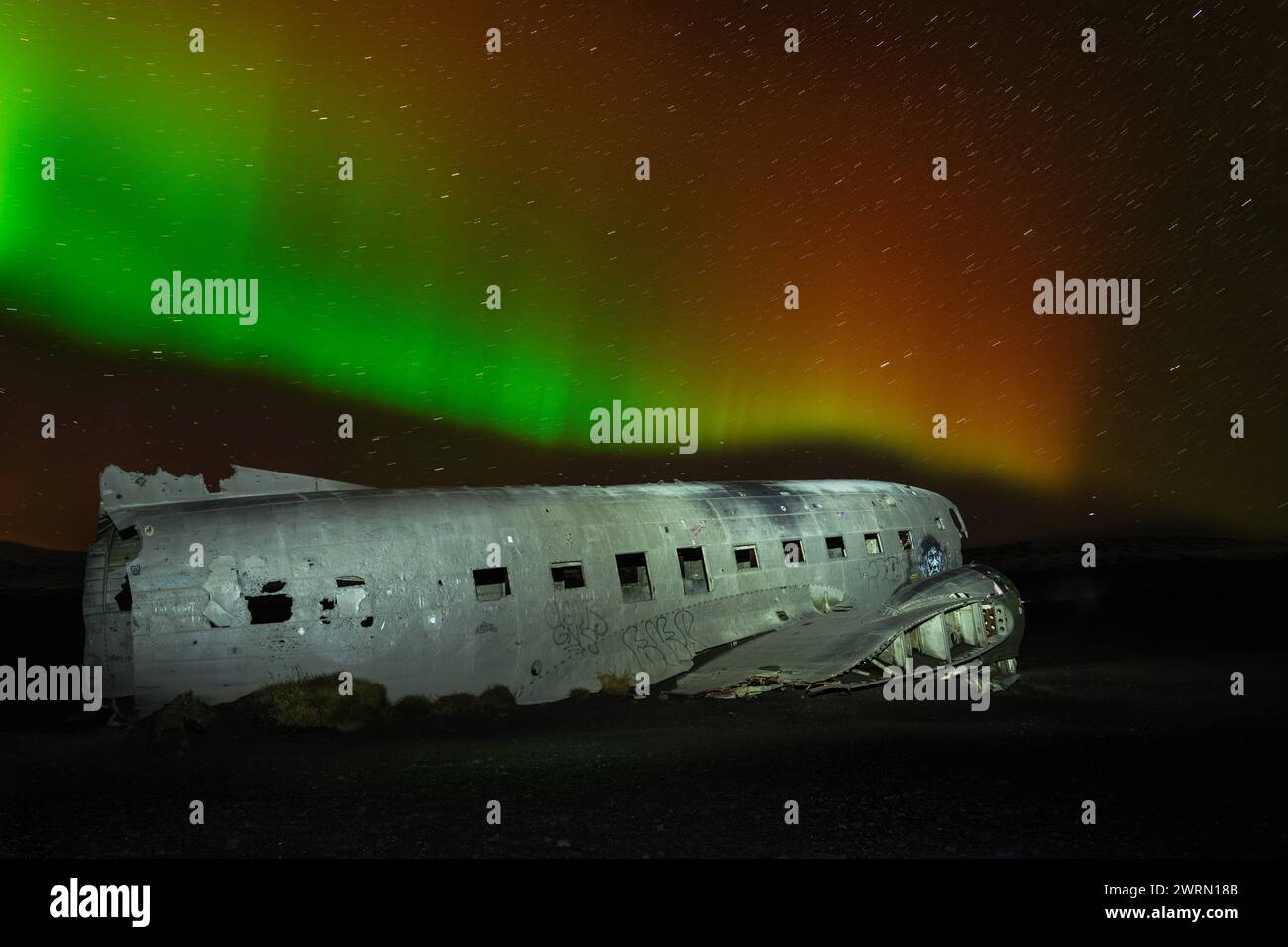 A crashed DC-3 aircraft under the Northern Lights Aurora Borealis in Iceland, Polar Regions Copyright: SpencerxClark 1320-268 Stock Photo