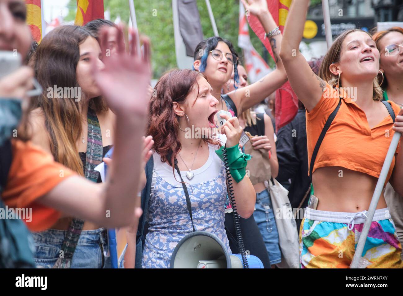 Buenos Aires, Argentina; March 8, 2024: group of young women chanting excited feminist slogans while marching during the international women strike. Stock Photo