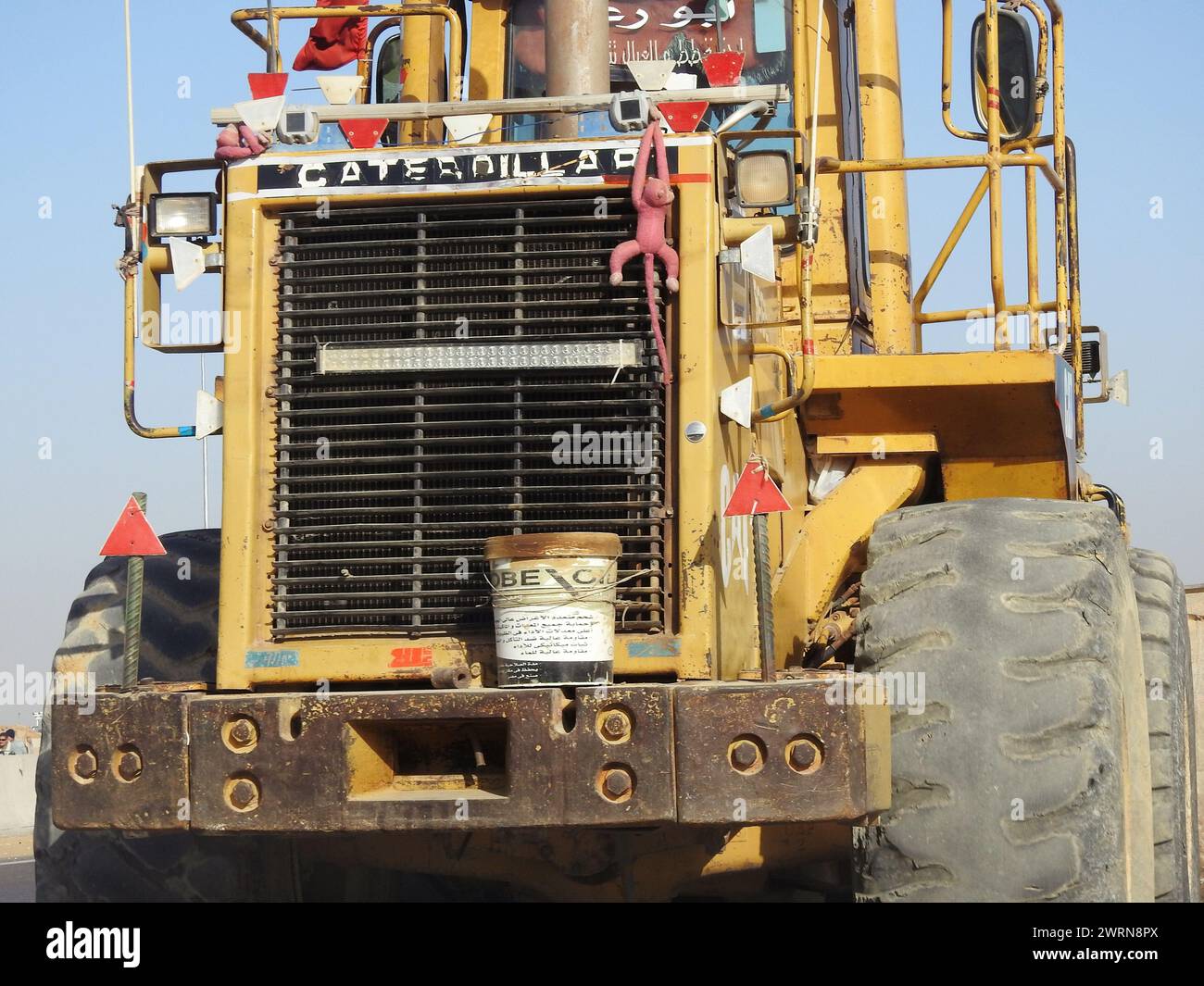 Cairo, Egypt, March 2 2024:  A front loader truck moving to a construction site, usually used for loading and transporting things from and to the cons Stock Photo