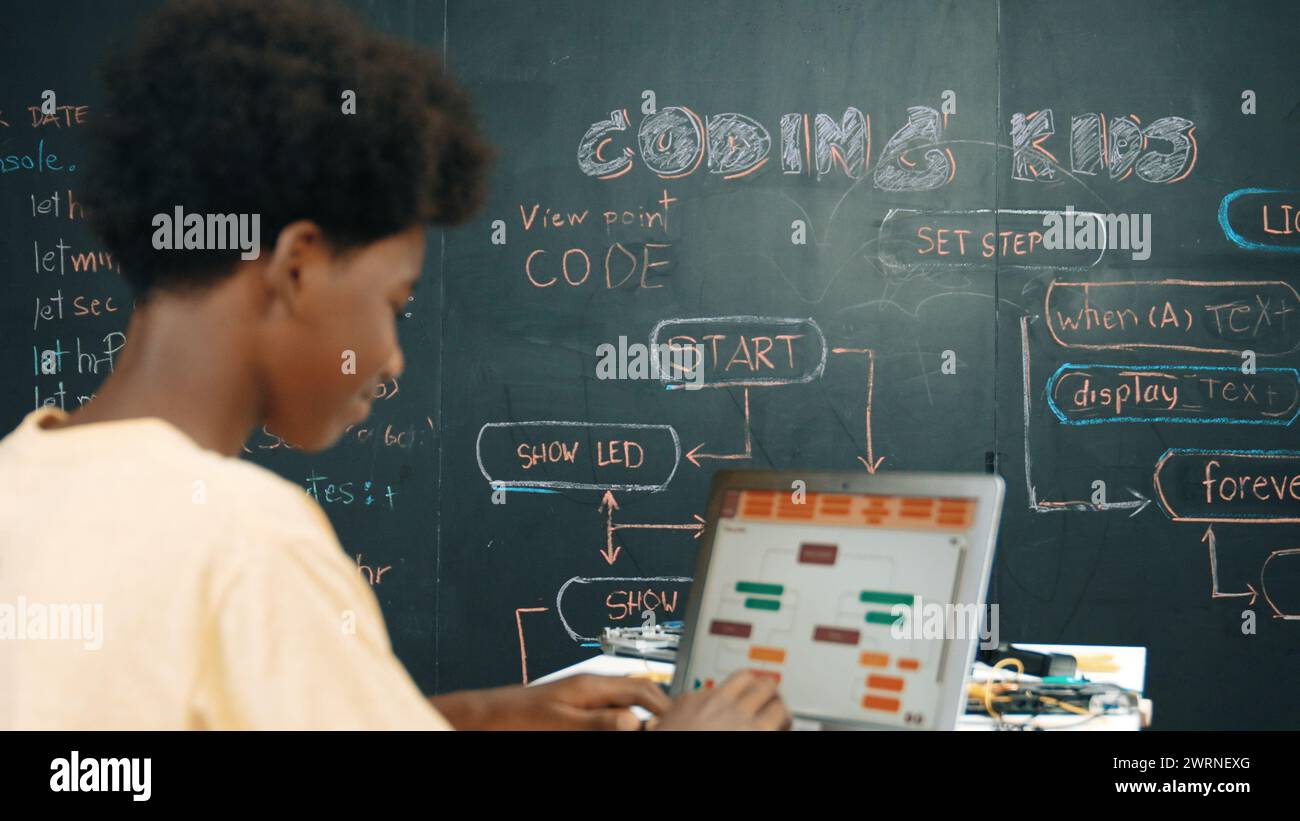 African boy using laptop programing system or coding prompt at ...