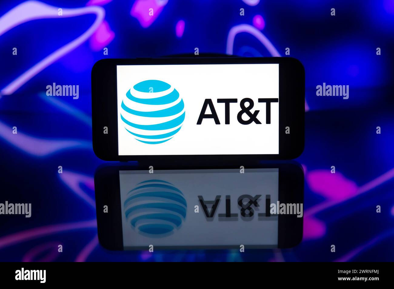 In this photo illustration, the AT&T logo is seen displayed on a mobile ...