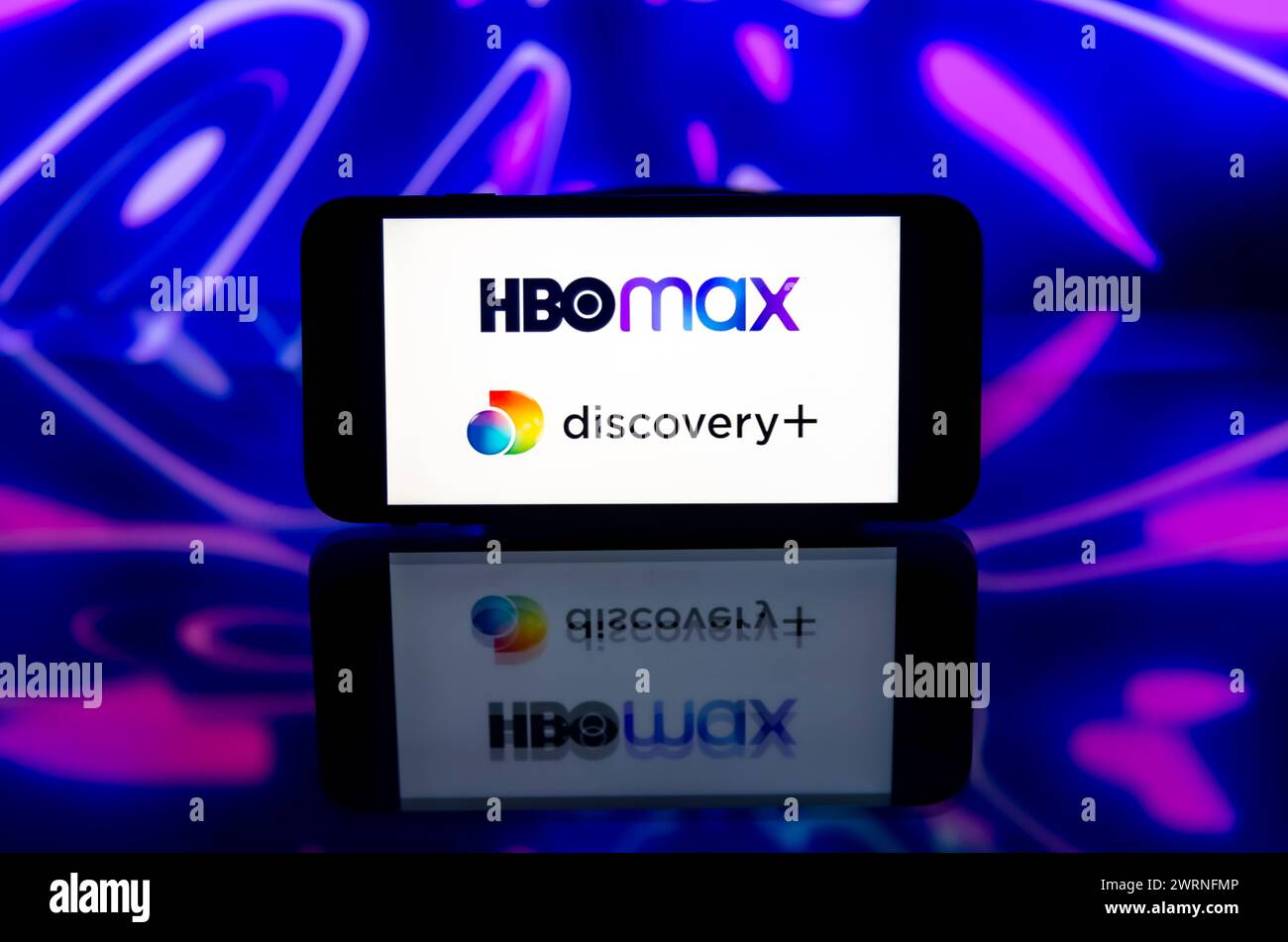 In this photo illustration, the HBO max and Discovery+ logo is seen ...