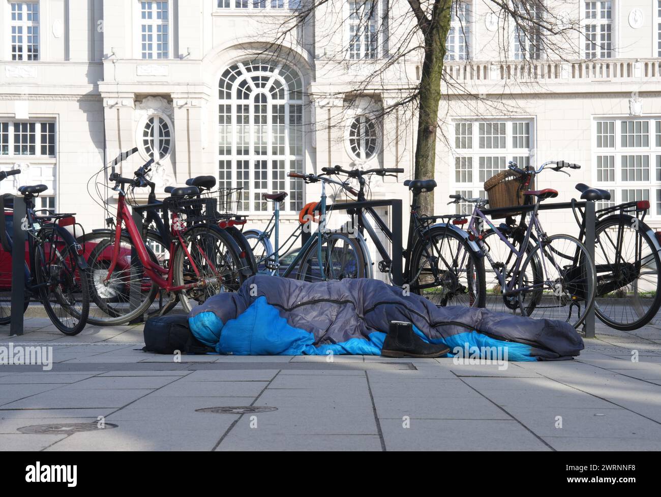 Hamburg, Germany. 01st Mar, 2024. A homeless man lies in his sleeping bag in the city center. Credit: Marcus Brandt/dpa/Alamy Live News Stock Photo