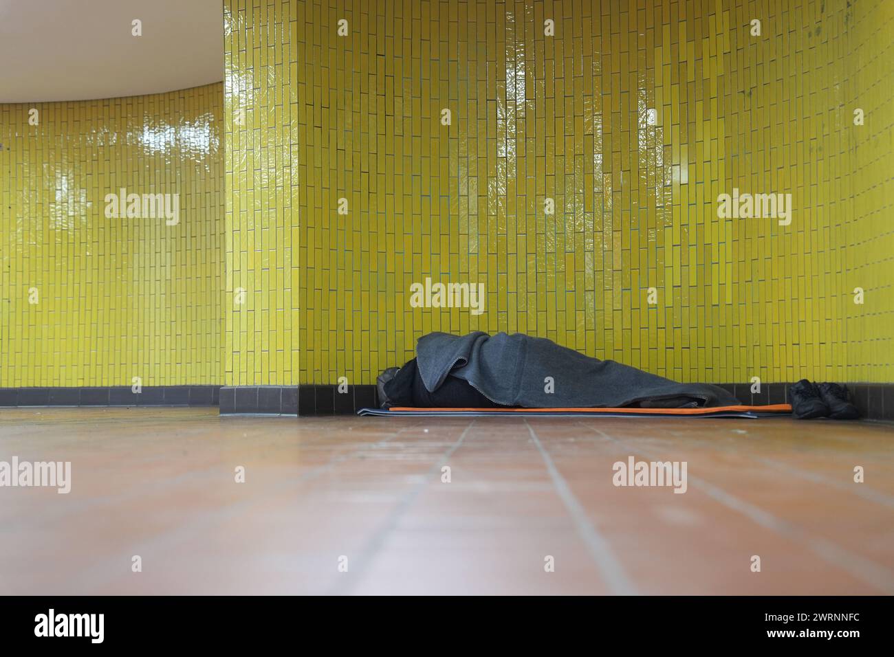 Hamburg, Germany. 01st Mar, 2024. A homeless man lies in his sleeping bag in a subway station in the city center. Credit: Marcus Brandt/dpa/Alamy Live News Stock Photo