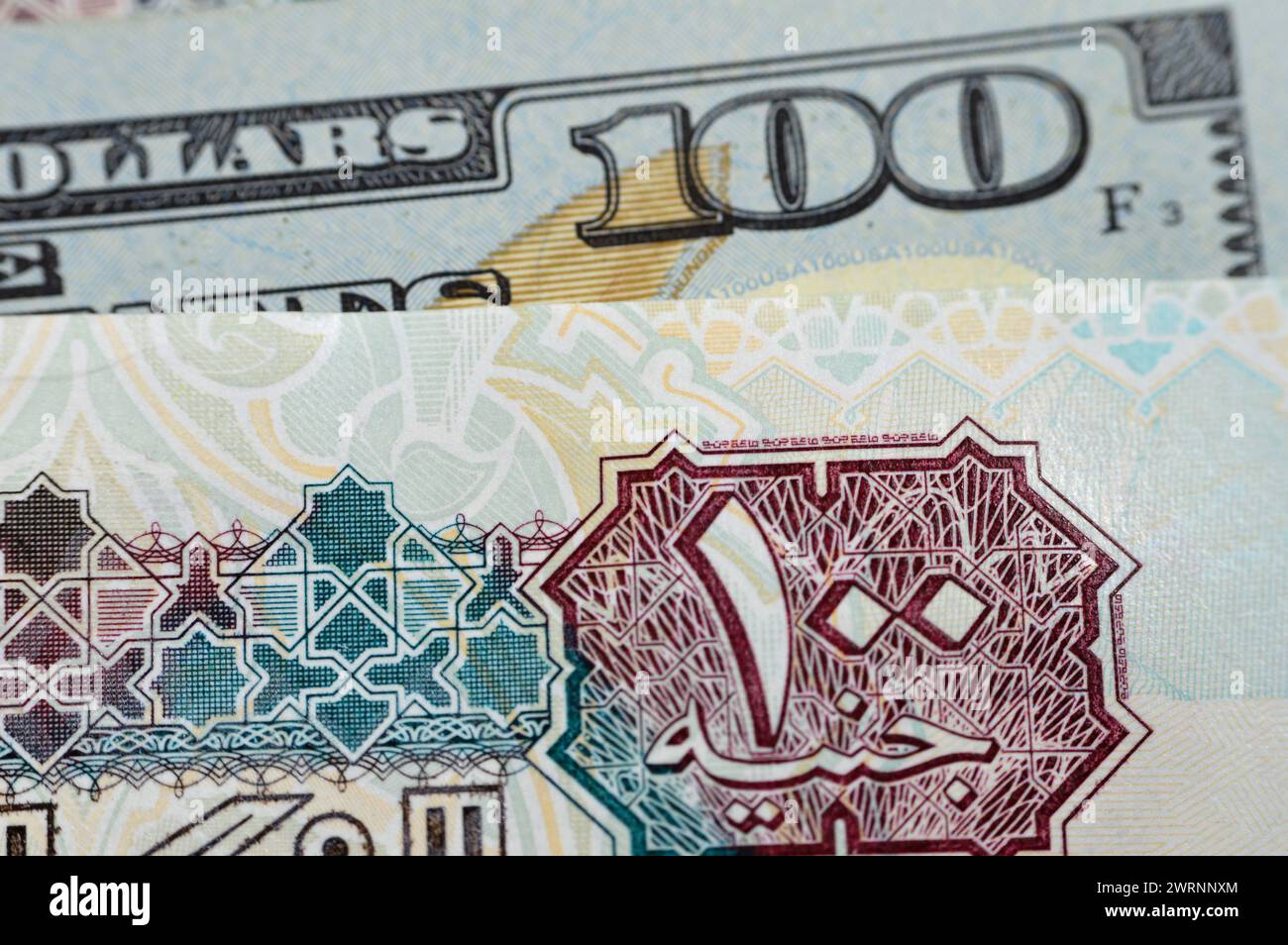 closeup-egyptian-money-banknotes-of-100-egp-le-one-hundred-pounds-bill-and-usd-american-cash-of-100-dollars-money-exchange-rates-of-egypt-and-united-2WRNNXM.jpg