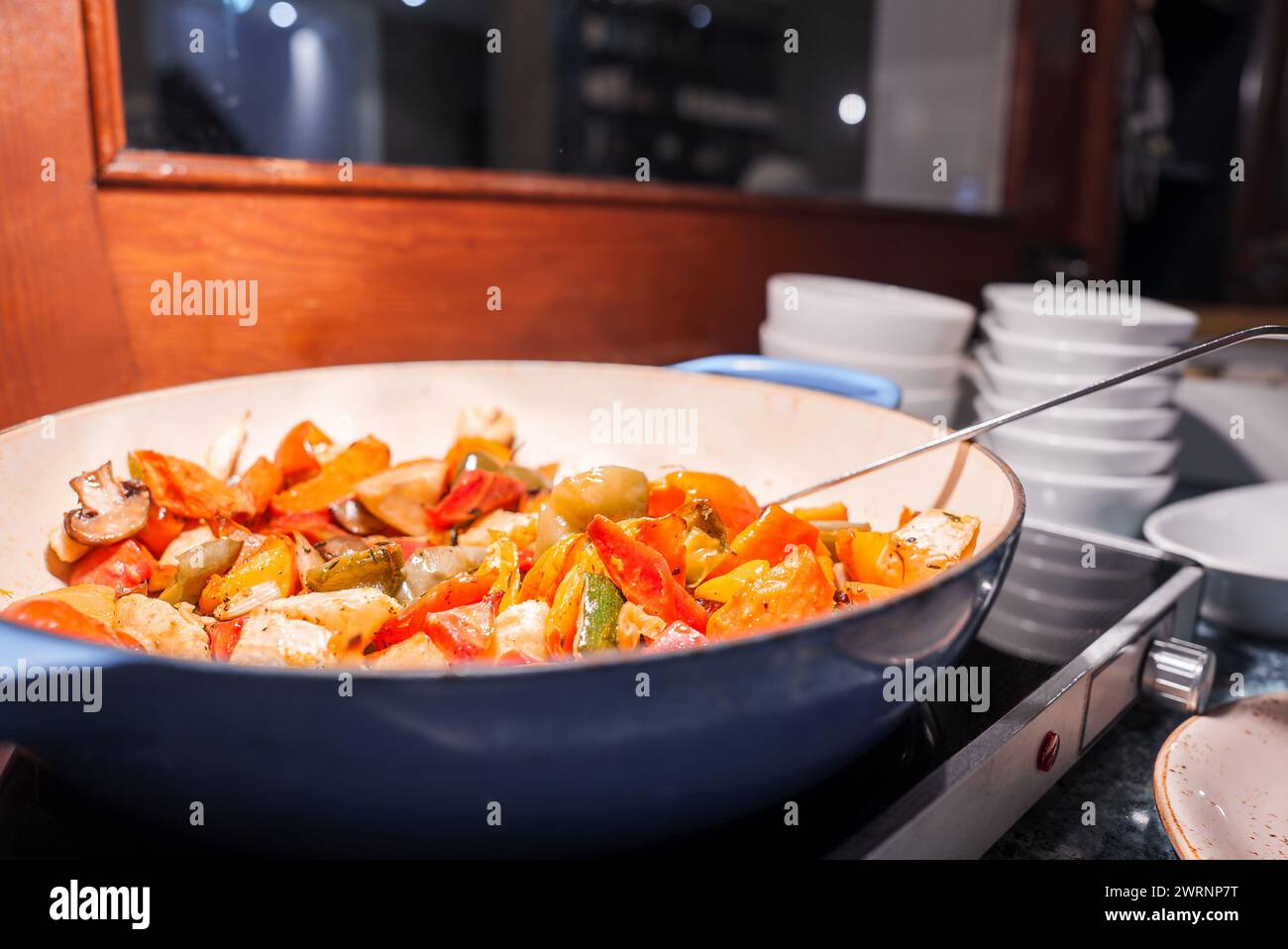 Colorful Veggie StirFry Served in a Blue Pan at Engelberg Luxury Hotel Stock Photo