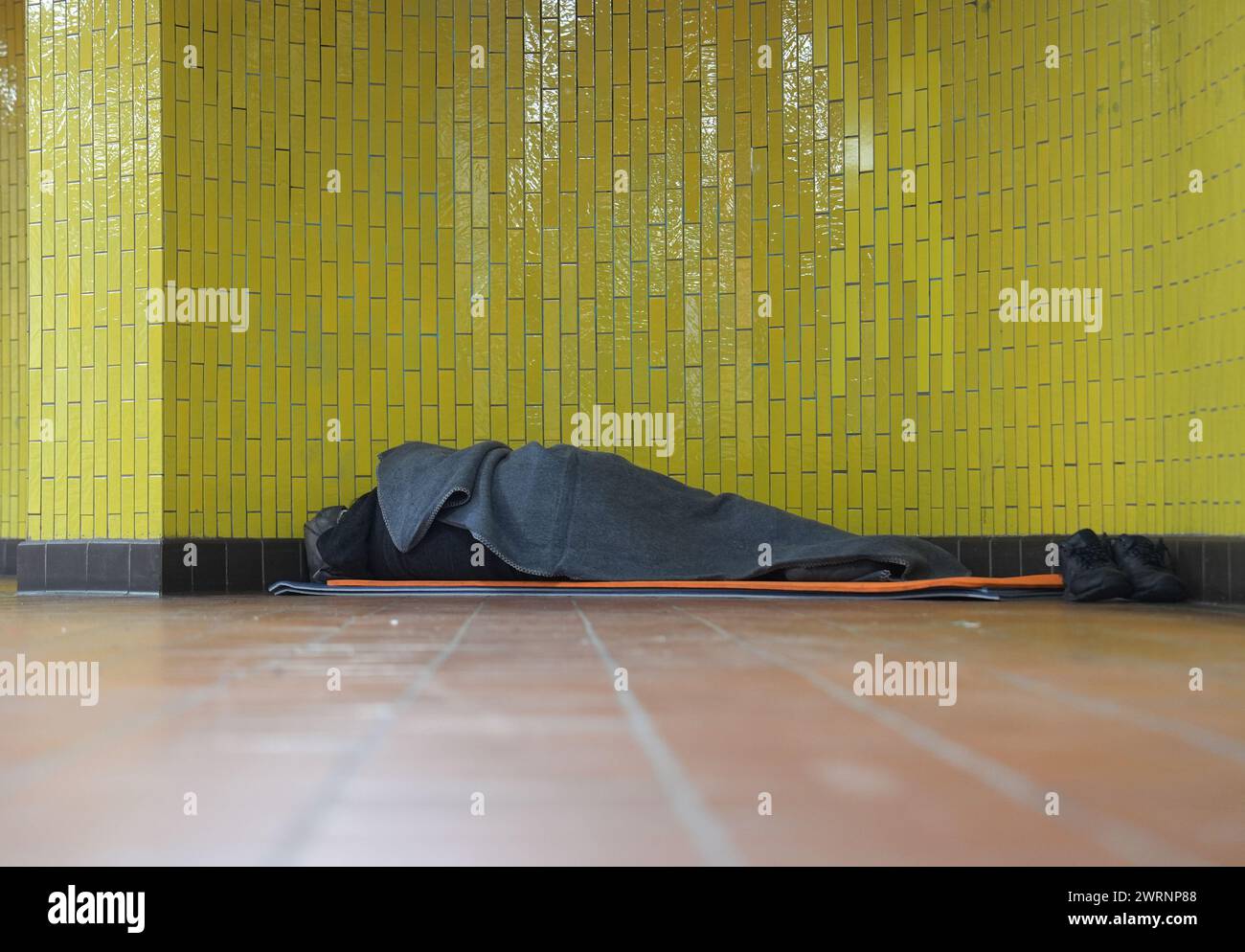 Hamburg, Germany. 01st Mar, 2024. A homeless man lies in his sleeping bag in a subway station in the city center. Credit: Marcus Brandt/dpa/Alamy Live News Stock Photo