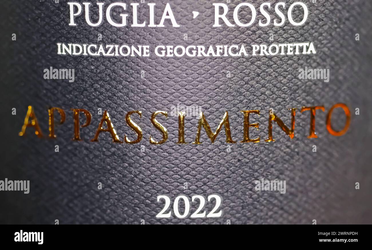 Viersen, Germany - March 9. 2024: Closeup of italian red wine bottle label with Appassimento making process for special flavor and origin of puglia ar Stock Photo