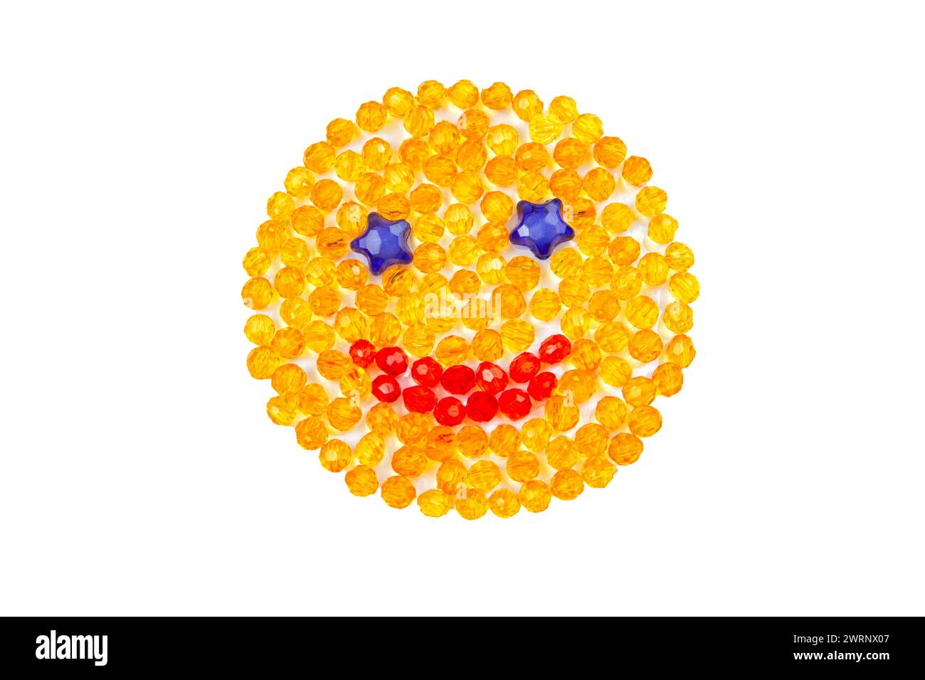 Smiling yellow smiley with beads on a white background. top view. Stock Photo