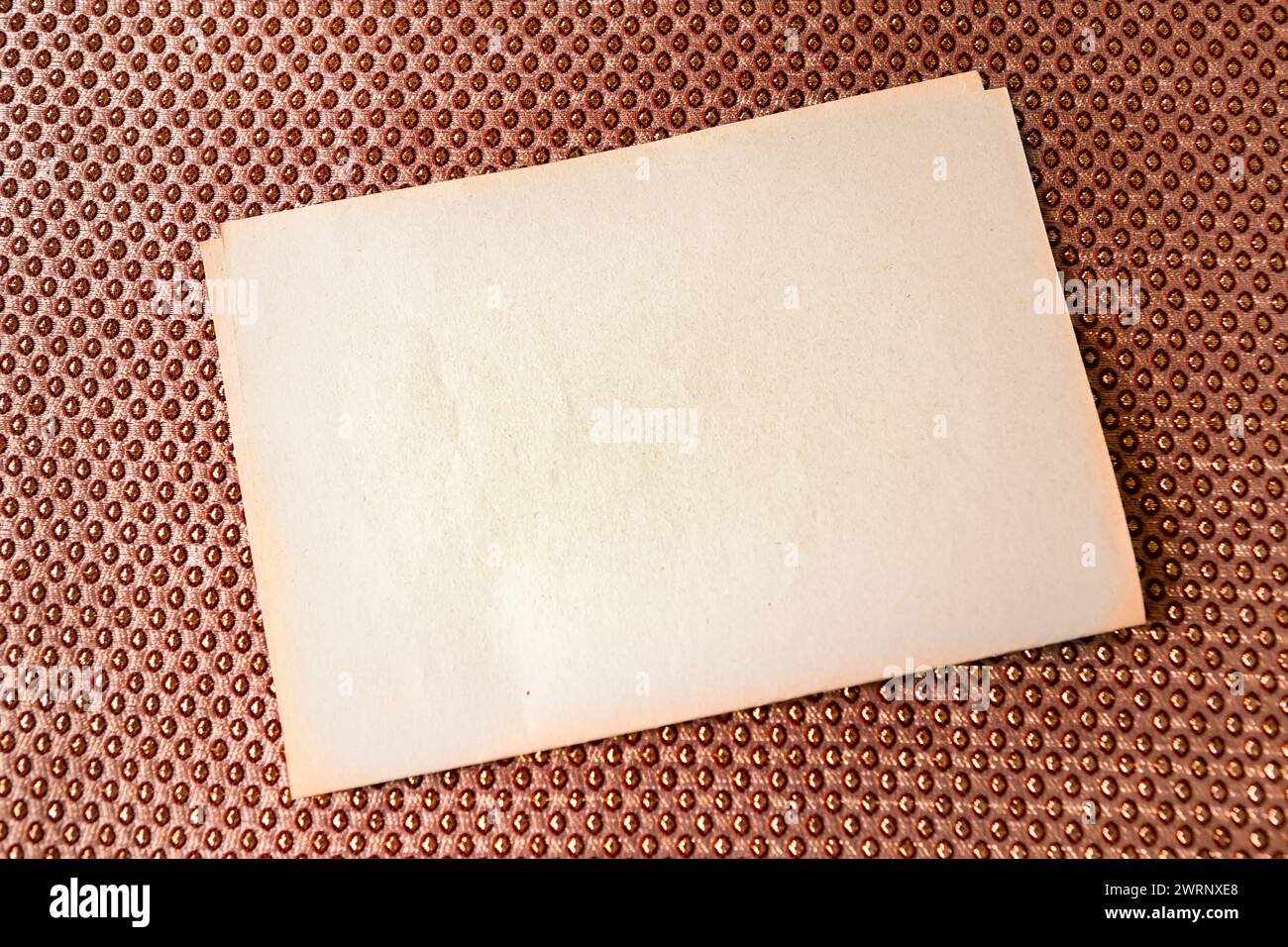 background of fabric in the highlight. gold color. sheet of paper on ...