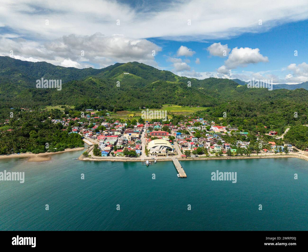 Beautiful landscape of town city in mountainside and coastal area in San Agustin, Romblon. Philippines. Stock Photo