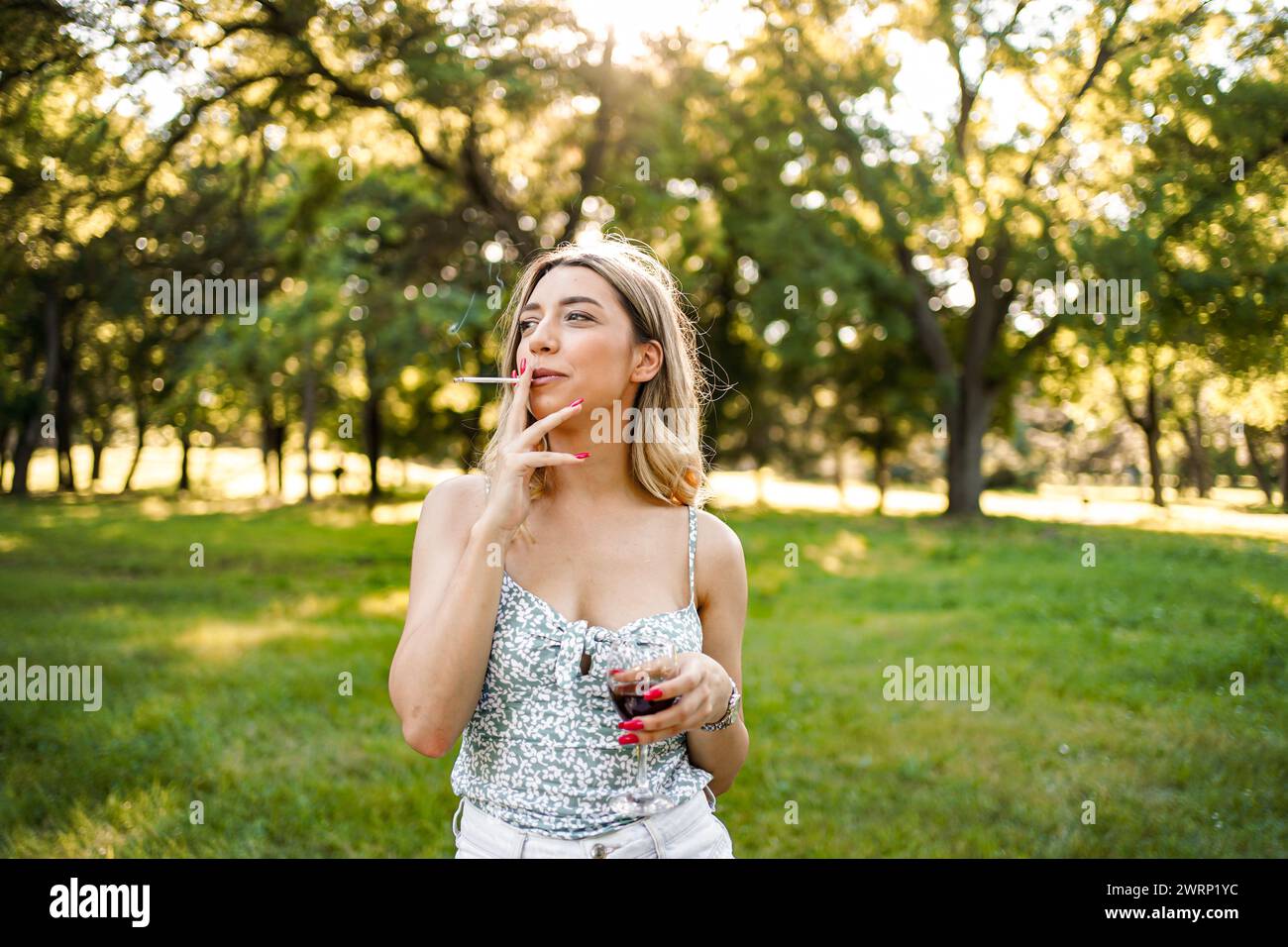 Portrait of blonde woman with cigar in outdoor Stock Photo - Alamy