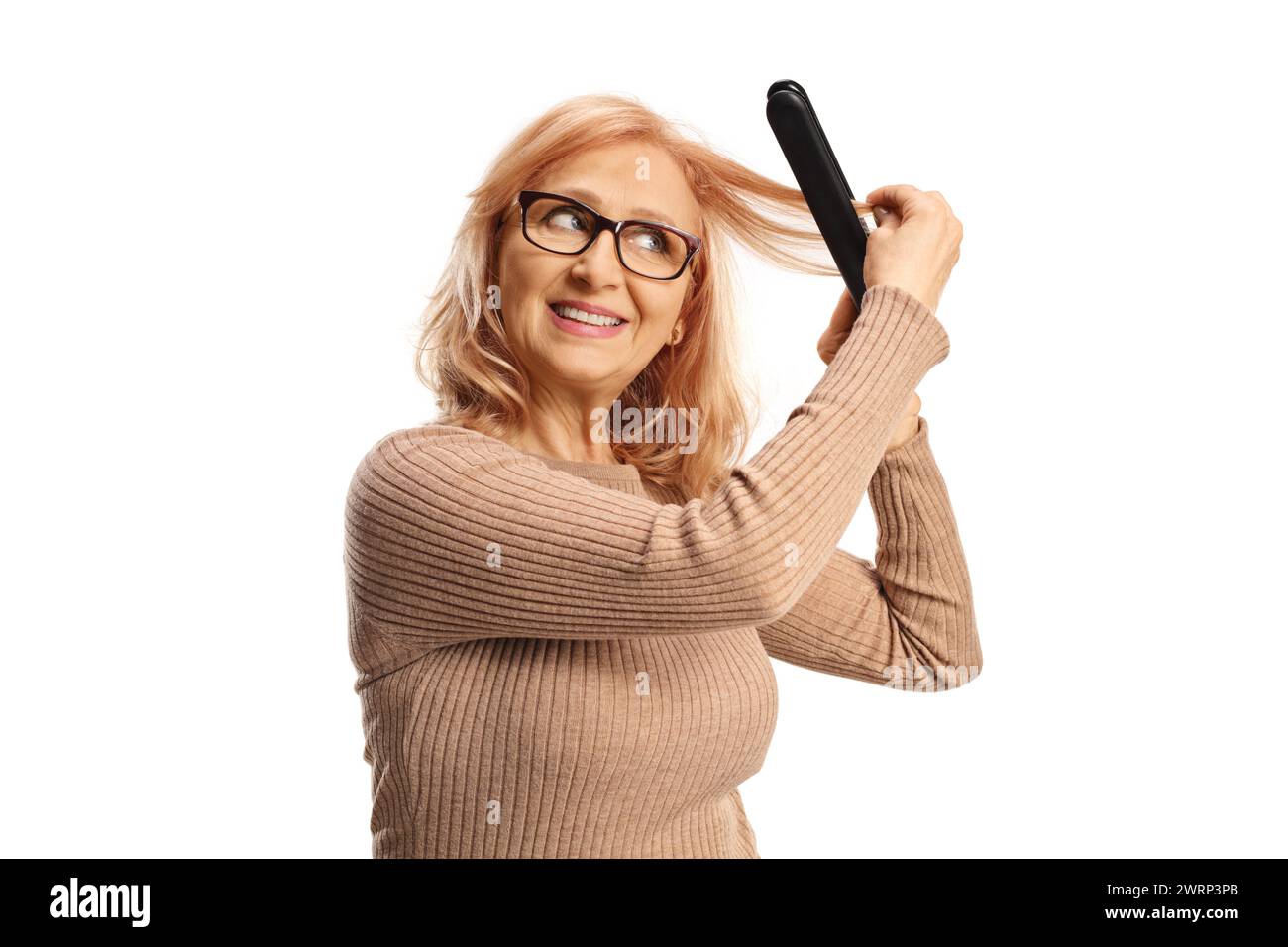 Woman using a wireless hair straightener isolated on white background Stock Photo