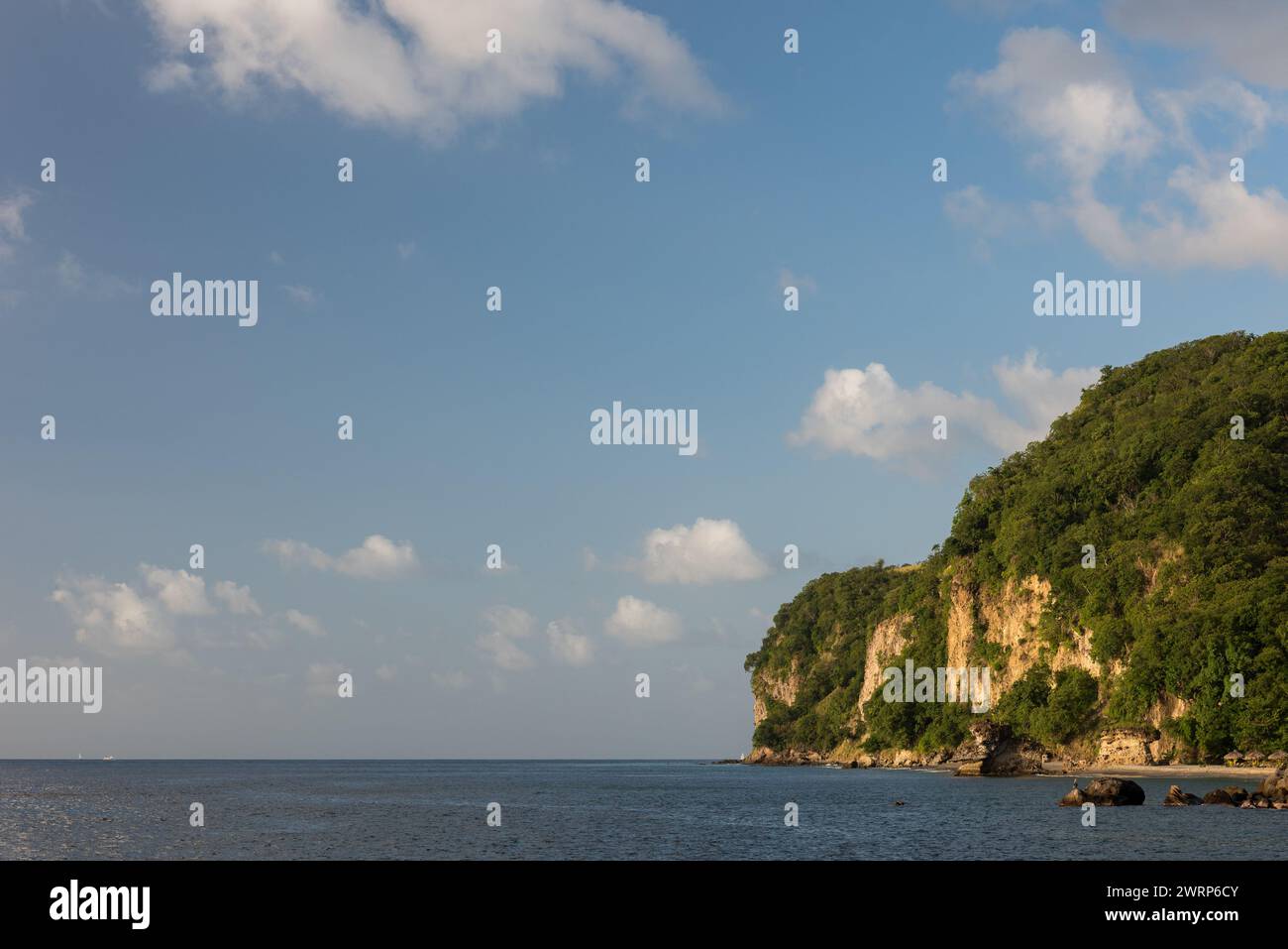 St. Lucia Island meets the Caribbean Sea with a landscape of cliffs in this secluded area of Anse Mamin Beach. Stock Photo