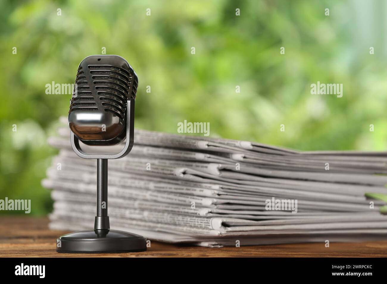 Newspapers and vintage microphone on table. Journalist's work Stock Photo