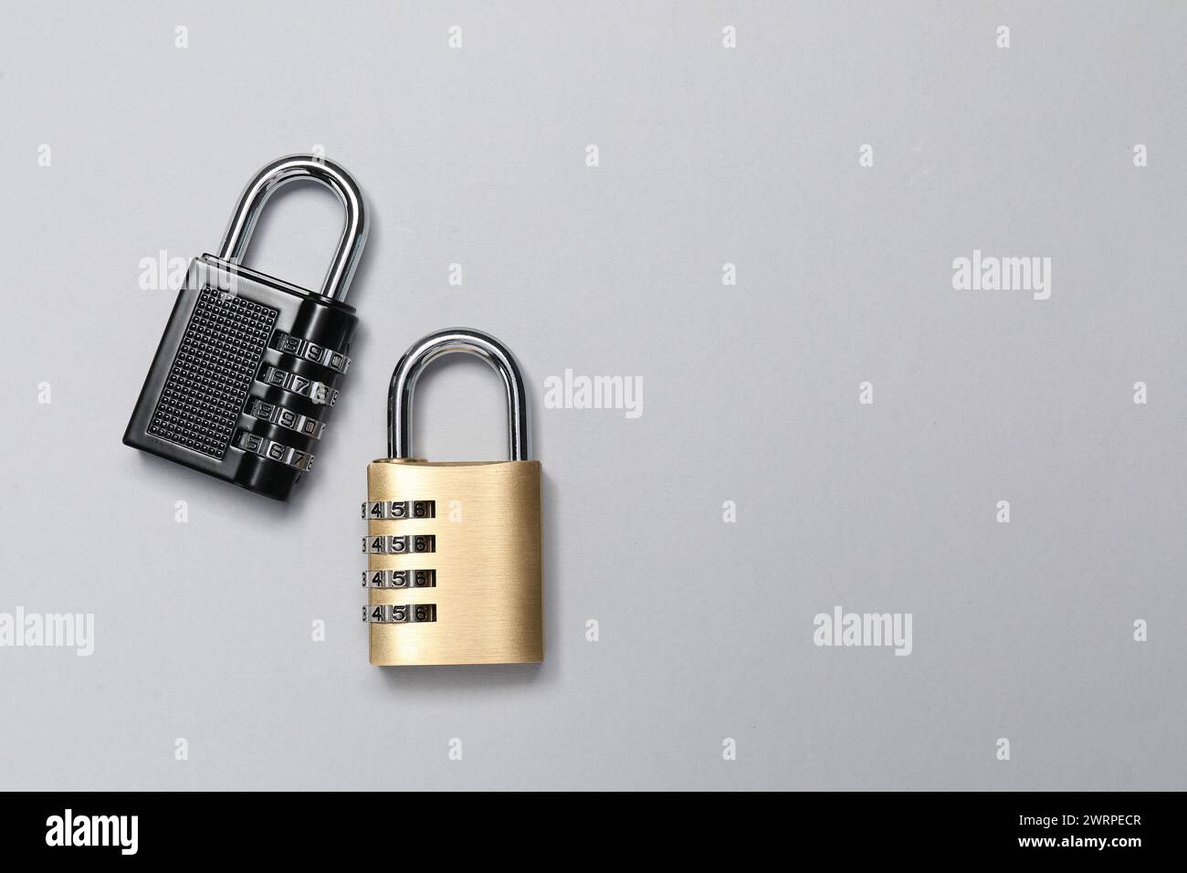 Steel combination padlocks on grey background, top view. Space for text Stock Photo