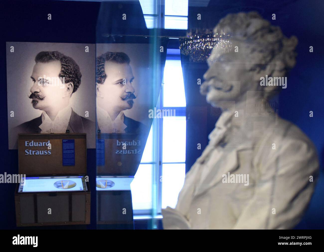 Vienna. 13th Mar, 2024. This photo taken on March 13, 2024 shows Eduard Strauss' potrait and Johann Strauss II's statue at the museum of House of Strauss, in Vienna, Austria. The House of Strauss provides visitors an interactive, audio-visual experience to know the Strauss family and their music. Credit: He Canling/Xinhua/Alamy Live News Stock Photo